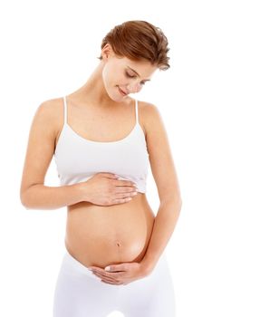 Pregnancy, love and woman holding her stomach in a studio for prenatal care, motherhood and happiness. Maternity, health and happy pregnant female model embracing her tummy by a white background.