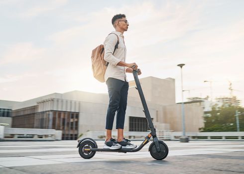 Young man, riding scooter and eco friendly for emission free future, sustainable and outdoor. Travel, casual business man and driving electric transport in city street, during day commute or journey