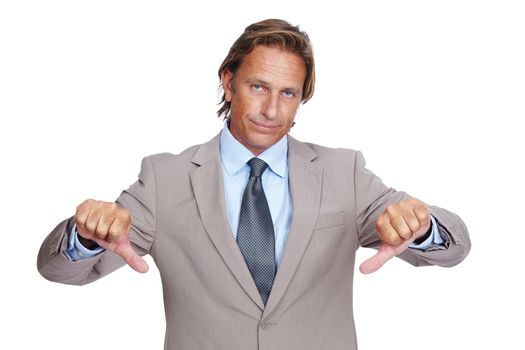 Businessman, thumbs down and upset in disappointment for failure against a white studio background. Portrait of a isolated business man pointing down thumbs in disapproval, wrong or incorrect gesture