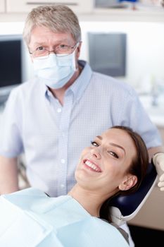 Doctor with smiling patient. Portrait of mature doctor with smiling patient in clinic.