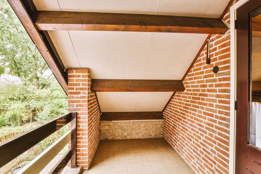 a long porch with brick walls and a wood ceiling