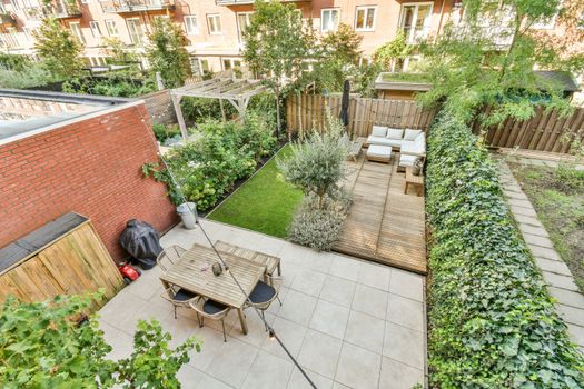 a small backyard with a wooden fence and a patio