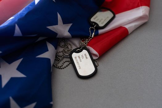 military forces, military service, patriotism and nationalism concept - close up of american flag and soldiers badges.