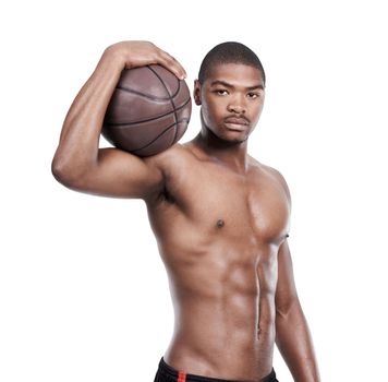 Determined to win. Portrait of a handsome young basketball player standing shirtless in the studio.