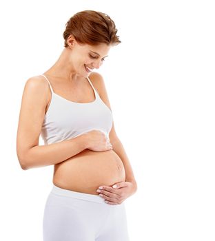 Pregnancy love, smile and happy woman with stomach on a white background in studio. Happiness, care and pregnant woman smiling at her pregnant abdomen on a studio background with mockup space