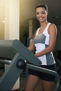 Exercise- her natural high. a young woman exercising on a treadmill at the gym.