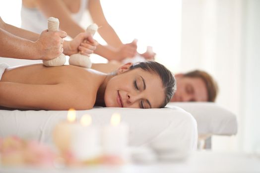 Blissful relaxation. A married couple receiving massages while at a spa.