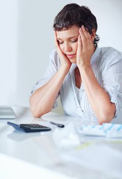 Doing taxes is exhausting. Mature business woman tired of calculating taxes in office.