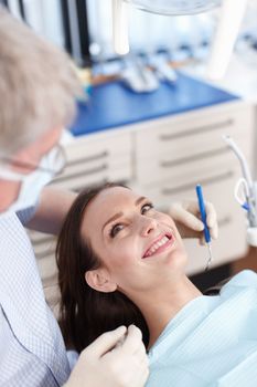 Patient on dental visit. High angle view of patient looking at dentist.