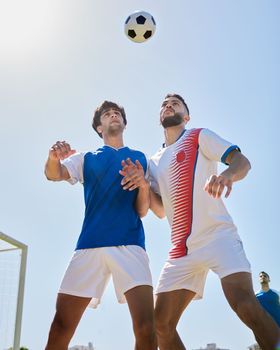 Sports, soccer and athletes doing a trick with ball on a field for a game, training or exercise. Fitness, football and men playing a match at a competition, tournament or championship on a pitch.