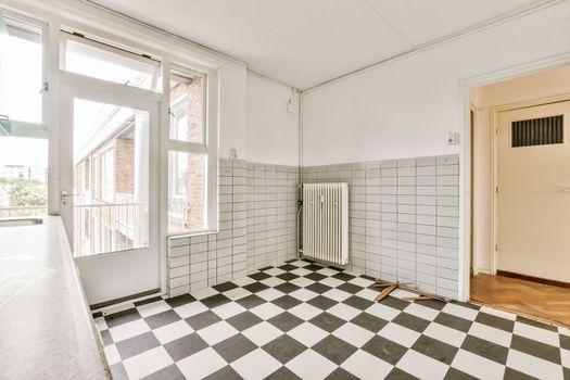 a renovated living room with a checkered floor