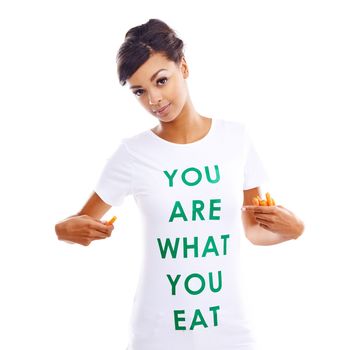 You are what you eat so make sure its healthy. Portrait of a young woman holding carrots while wearing a t-shirt saying you are what you eat.