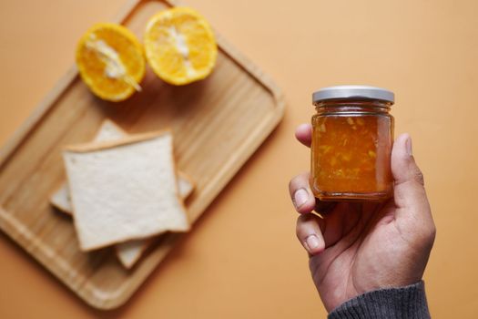 orange fruit spread in a container top view 