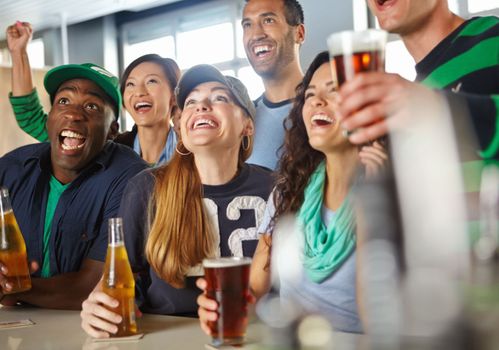 Come on. A group of friends cheering on their favourite sports team at the bar.