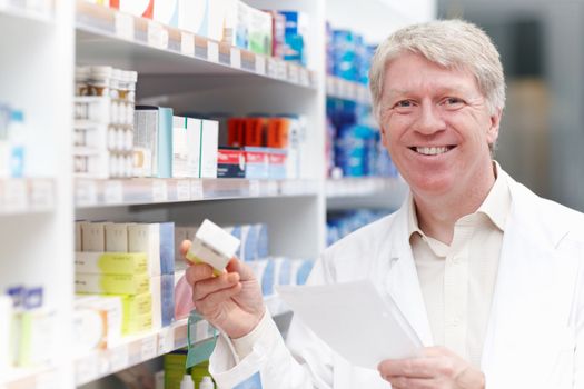 Smiling pharmacist with medicine and prescription. Portrait of smiling pharmacist with medicine and prescription.