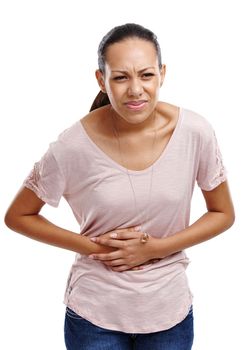 Woman in a studio with stomach pain, injury or sickness from indigestion or constipation. Discomfort, uncomfortable and female model with a menstrual tummy ache or sore isolated by a white background