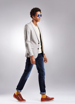 Simplicity is the ultimate sophistication. Studio shot of a fashionable young man against a gray background.