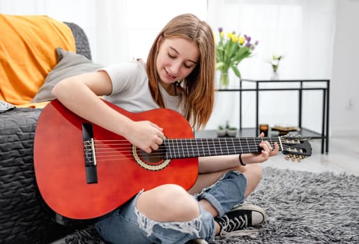 Girl teenager practicing guitar playing