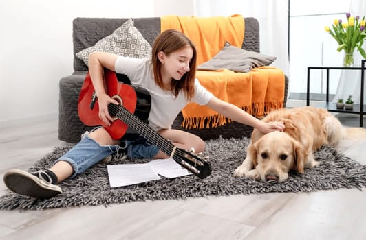 Girl teenager practicing guitar playing