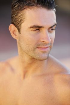 Hes the picture of masculine health. Closeup of a handsome young topless man looking sideways.