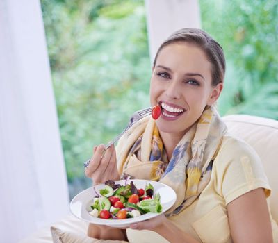 Eat healthy, be healthy. Portrait of a young woman enjoying her salad.