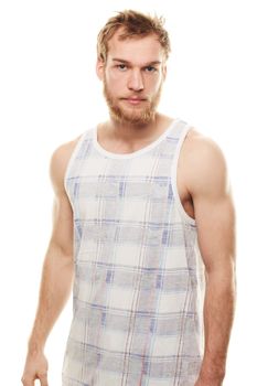 Confidence in a tank top. Portrait of a young man wearing a vest isolated on white.