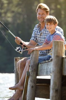 Casting off together. a father and son bonding over a fishing trip.