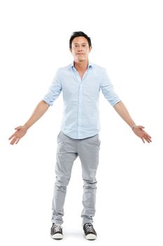 Its this wide. Studio portrait of a young man standing with his arms outstretched against a white background.