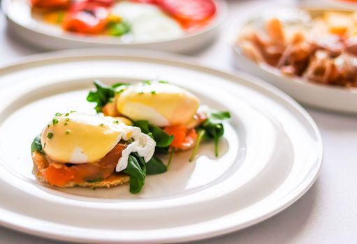 Luxury breakfast, brunch and food recipe, poached eggs with salmon and greens on gluten-free toast for restaurant menu and gastronomy