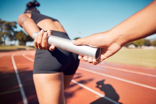 Fitness, woman and hands on baton for relay sports, training or running competition on the stadium track. Active female in athletics sport holding bar for competitive race, sprint or team marathon
