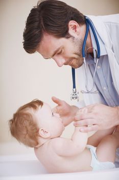 Hes the best doctor in the field. A male doctor doing a physical examination of an infant girl.