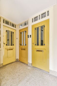 a pair of yellow doors at the entrance of a