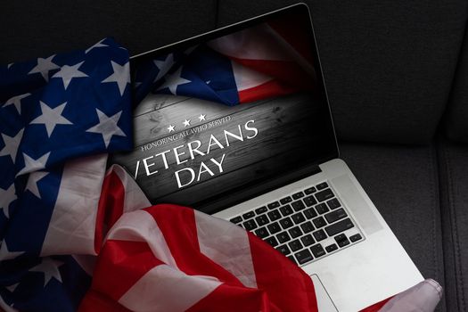 laptop with usa flag and inscription veterans day