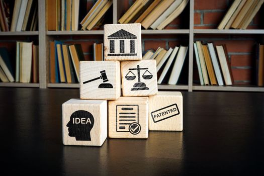 Copyright or patent law concept. Wooden cubes with marks on the desk.
