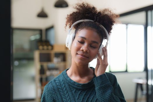 Young Black Woman Listening To Music Online Wearing Wireless Earphones, Enjoying Favorite Song. Playlist, Music Application