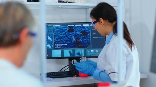 Woman research chemist testing virus sample