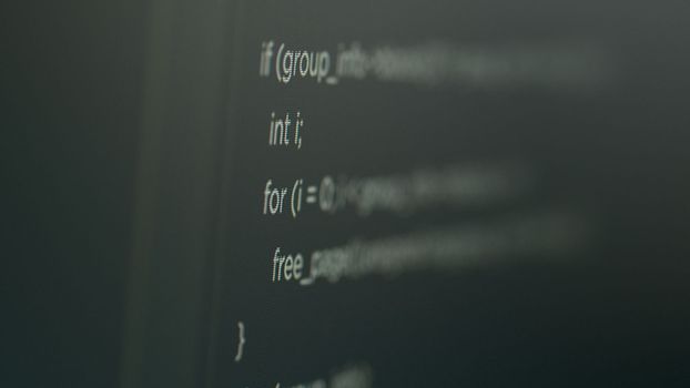 Program code on computer screen with software development database