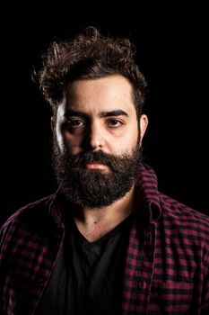 Portrait of bearded man on black background
