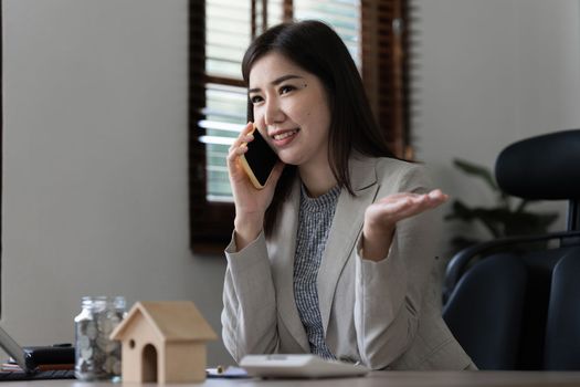 Portrait of Happy asian woman talking with friend by cell phone