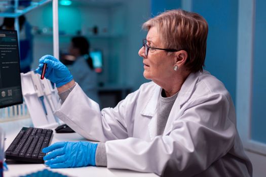 Scientist analysing blood test sample in medical facility