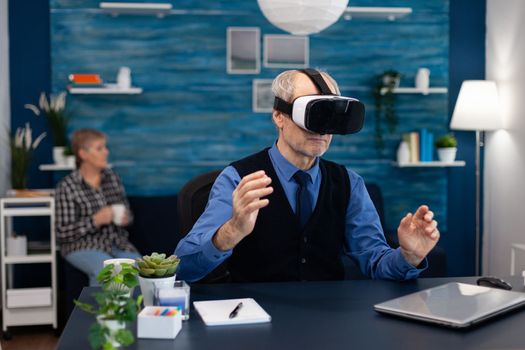 Senior man wearing virtual reality headset