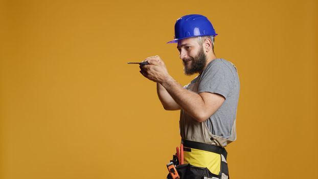 Industrial repairman working with screwdriver to turn nails and bolts
