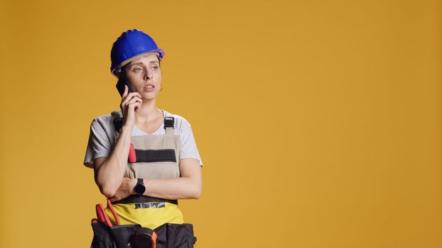 Portrait of empowered handywoman answering phone call