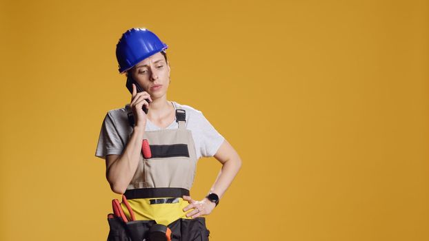 Female contractor talking on mobile phone call