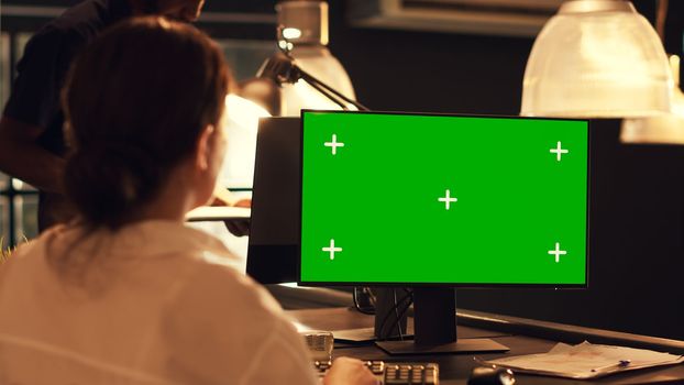 Woman working with greenscreen template on computer