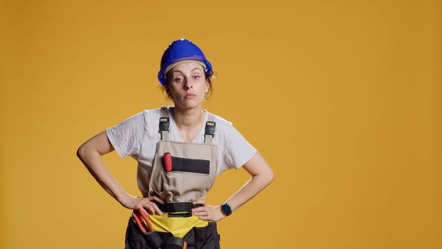 Portrait of tired drained handywoman yawning after building work