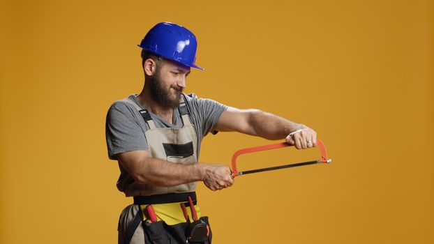 Handyman mechanic using saw with razor used for chopping wood