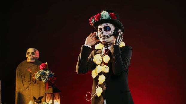 Horror model with costume of death dancing in studio