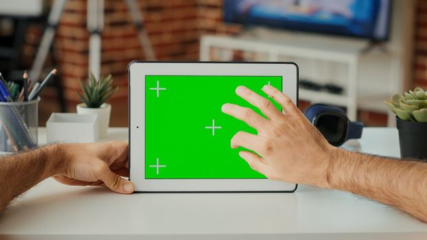 Male freelancer looking at horizontal greenscreen on display