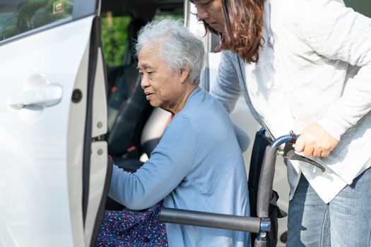 Asian senior or elderly old lady woman patient sitting on wheelchair prepare get to her car, healthy strong medical concept.